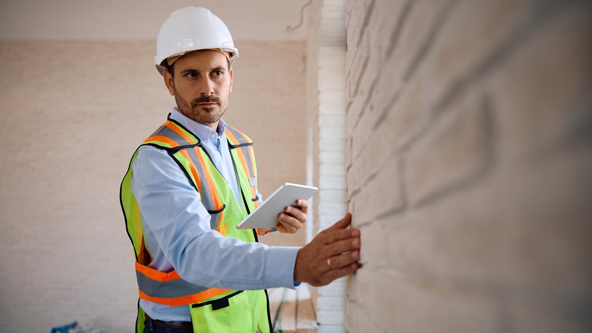 Construction professional reviewing monitored jobsite conditions